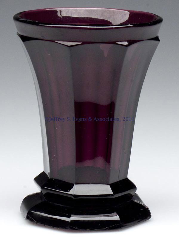 PRESSED EIGHT-PANEL FLOWER STAND / VASE: PRESSED EIGHT-PANEL FLOWER STAND / VASE, amethyst, conical bowl with a plain circular rim and a ringed base, raised on a slight hexagonal foot with a polished pontil mark. Probably New England. 1850-1