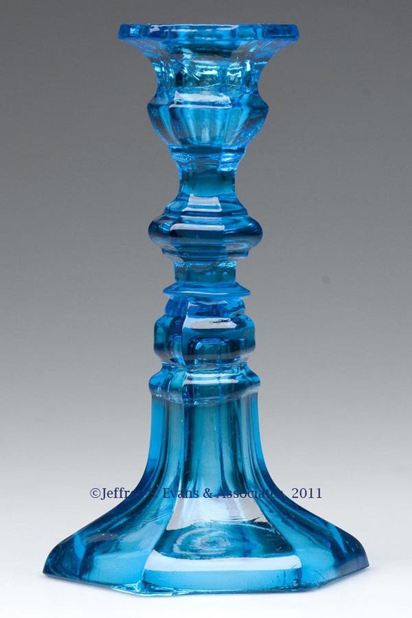 PRESSED HEXAGONAL CANDLESTICK: PRESSED HEXAGONAL CANDLESTICK, electric blue with some olive green striations, hexagonal socket and compressed knop extension raised on a flared hexagonal base, wafer construction. Light rough snap ri