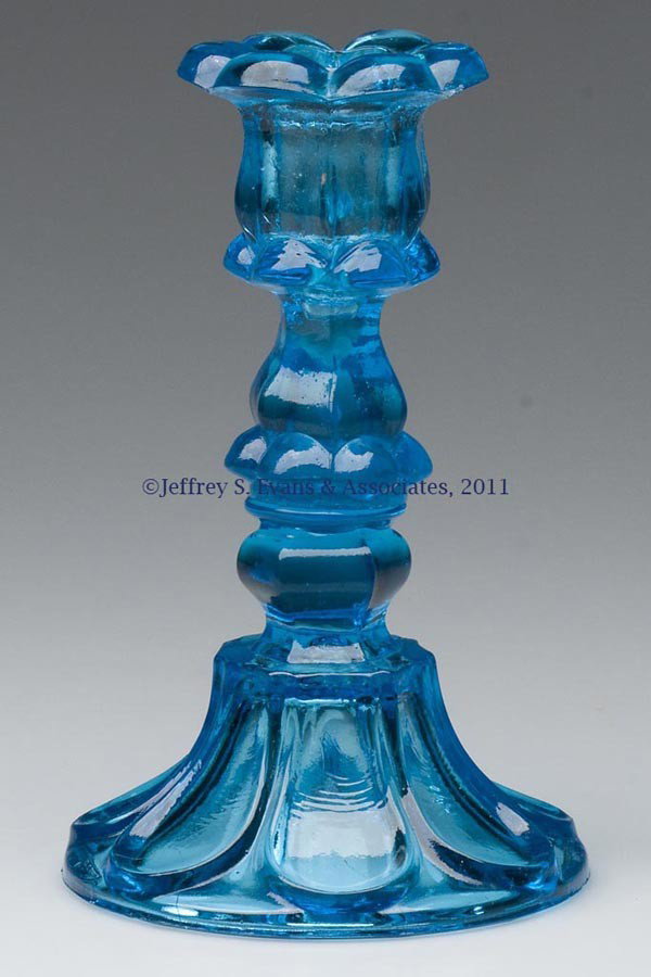 PRESSED PETAL AND LOOP CANDLESTICK: PRESSED PETAL AND LOOP CANDLESTICK, medium electric blue, six-petal socket with a hexagonal extension, raised on a hexagonal knop and seven-loop circular base with rough pontil mark, wafer constructio