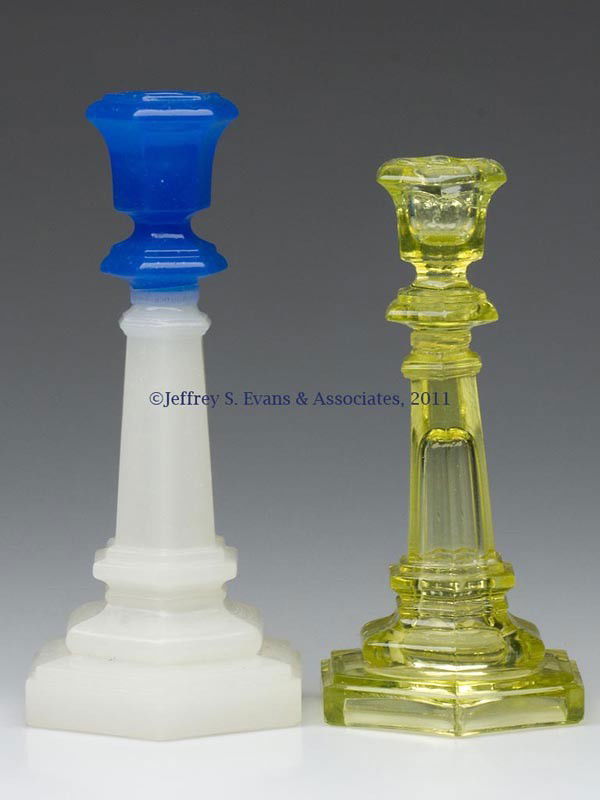 TWO PRESSED HEXAGONAL CANDLESTICKS: TWO PRESSED HEXAGONAL CANDLESTICKS, canary yellow and starch blue over alabaster/clambroth with shiny surface, each with an urn-form socket with lower bladed knop, raised on a tapered stem and double-