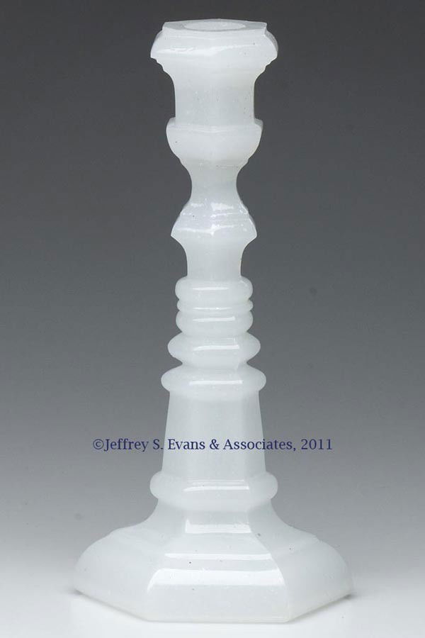 PRESSED HEXAGONAL CANDLESTICK: PRESSED HEXAGONAL CANDLESTICK, alabaster/clambroth, medium size, urn-shape socket with a double-knop extension, raised on a hexagonal base with a ringed standard, wafer construction. Probably Boston &