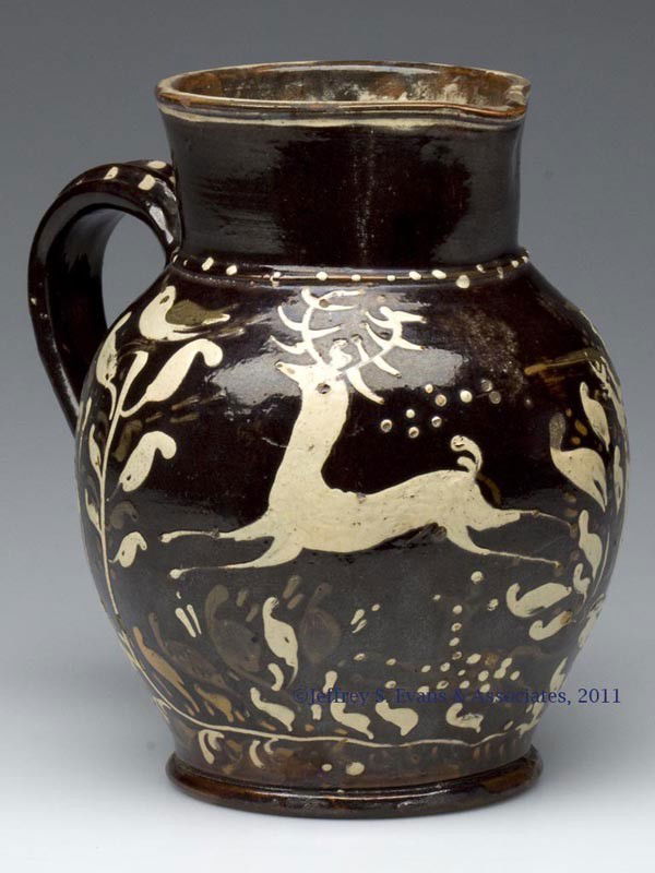 RARE 1842 SLIP-DECORATED EARTHENWARE PITCHER: RARE 1842 SLIP-DECORATED EARTHENWARE PITCHER, manganese and lead glazed with dark green, white and tan slip, bulbous form with a heavy beaded neck ring, grooved rim, double-rib strap handle, and prono