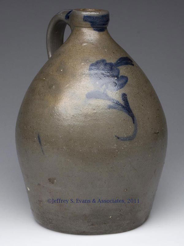 MID-ATLANTIC DECORATED STONEWARE JUG: MID-ATLANTIC DECORATED STONEWARE JUG, salt glazed, approximately 1 gallon capacity, broad ovoid form with bold squared mouth, brushed cobalt "spitting tulip" decoration, additional cobalt on mouth and
