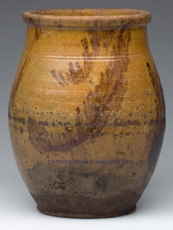 PENNSYLVANIA DECORATED EARTHENWARE JAR: PENNSYLVANIA DECORATED EARTHENWARE JAR, double lead glazed with splashes of manganese, graceful ovoid form with two incised rings below the rounded rim, pronounced beaded foot. 1830-1850. 8 3/4" H, 5