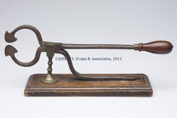 STEEL TABLE-TOP SUGAR NIPPERS: STEEL TABLE-TOP SUGAR NIPPERS, turned wooden handle and brass standard, raised on a walnut molded-edge base with line inlay. First half 19th century. 6" H, 3 1/2" x 11" base. Provenance: Estate collec