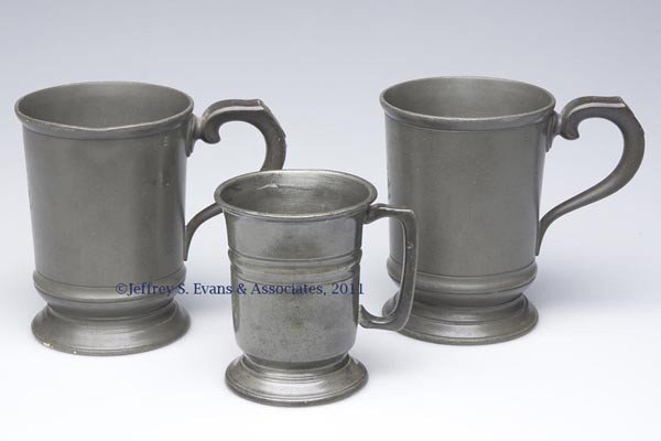 PEWTER TANKARDS, LOT OF THREE: PEWTER TANKARDS, LOT OF THREE, comprising a pair of pints with matching monograms, and one half-pint, also monogrammed. Each with various touch marks including a crown and "VR". Probably 19th century.