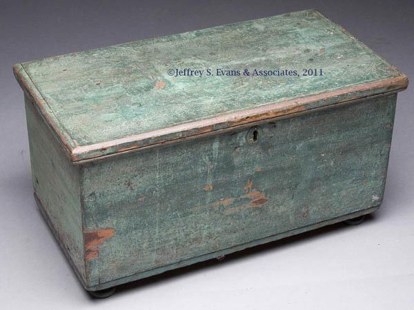 COUNTRY PAINTED SOFTWOOD MINIATURE BLANKET CHEST: COUNTRY PAINTED SOFTWOOD MINIATURE BLANKET CHEST, hinged lid with applied moldings above a dovetailed box raised on turned feet. Interior fitted with a lidded till, butt hinges and a later cabinet loc