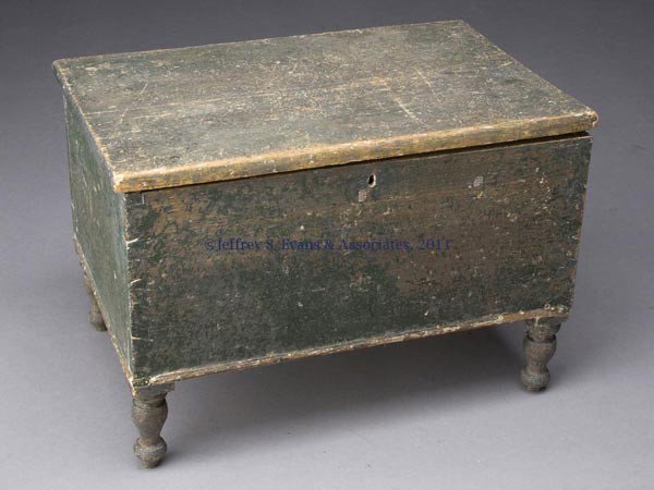 COUNTRY PAINTED SOFTWOOD MINIATURE CHEST: COUNTRY PAINTED SOFTWOOD MINIATURE CHEST, hinged-lid above a dovetailed case raised on tall well-turned feet mortised through the bottom. White painted open interior with simple butt hinges and a smal