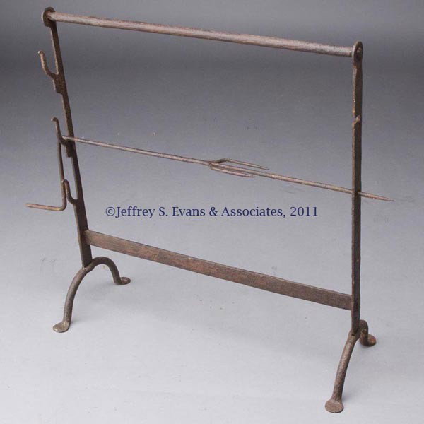 WROUGHT-IRON ADJUSTABLE SPIT: WROUGHT-IRON ADJUSTABLE SPIT, three heights, with penny feet. 18th or 19th century. 25 3/8" H, frame 23" L, 9" W at foot. Provenance: Estate collection of Dorothy and Marshall Jenkins.