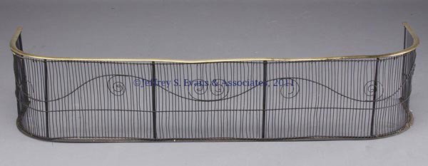 BRASS AND WIRE FIREPLACE FENDER: BRASS AND WIRE FIREPLACE FENDER, D-shape form with scrolled decorations. First half 19th century. 10" H, 46 1/2" W, 12" D. Provenance: From a Williamsburg, VA collection.