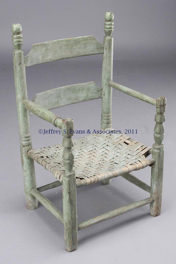 SOUTHERN PAINTED CHILD'S ARM CHAIR: SOUTHERN PAINTED CHILD'S ARM CHAIR, two-slat back with complex ball-and-ring post finials above turned arms mortised into the front finial-top posts, woven splint seat, and box-like stretchers. Histor