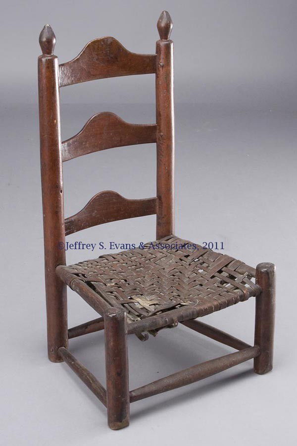 AMERICAN PAINTED CHILD'S SIDE CHAIR: AMERICAN PAINTED CHILD'S SIDE CHAIR, back with three boldly shaped slats and ovoid-form post finials, woven splint seat, and box-like stretchers. Historical red-washed surface. Late 18th/early 19th ce