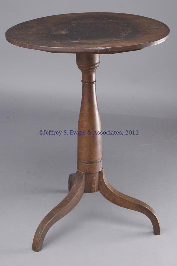 AMERICAN SHAKER-STYLE CANDLESTAND: AMERICAN SHAKER-STYLE CANDLESTAND, birch and cherry, oval tilting top raised on a ring-turned tapered pedestal and tripod base. Original dry surface. Mid 19th century. 40 1/4" HOA, 28 1/2" H down, 15