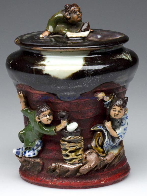 JAPANESE SUMIDA HUMIDOR - TEA CADDY: JAPANESE SUMIDA HUMIDOR - TEA CADDY, featuring three applied figures and an applied mark. Late 19th to mid 20th century. 6" HOA, 4 1/4" DOA. Provenance: Collection of Bertram (Bert) Cohen.