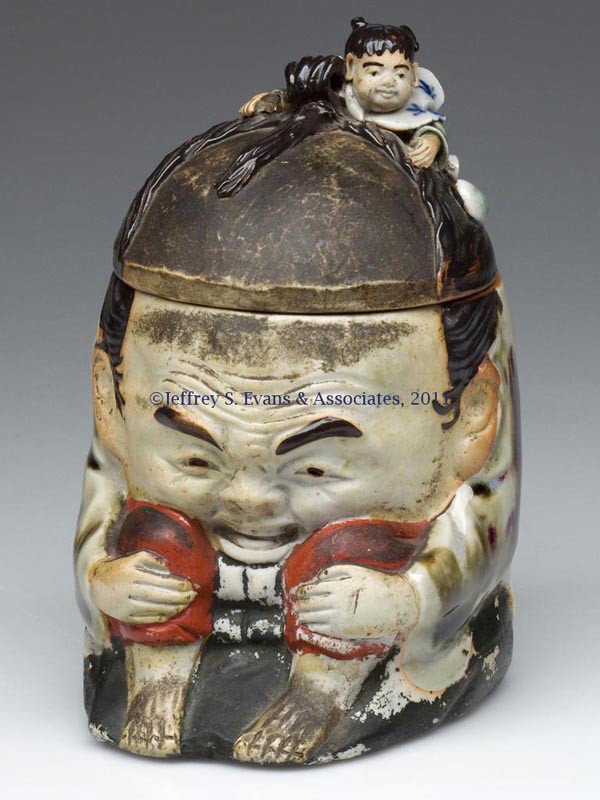 JAPANESE SUMIDA CROUCHING MAN HUMIDOR: JAPANESE SUMIDA CROUCHING MAN HUMIDOR, with applied figure to cover and applied mark to lower edge of base. Late 19th to mid 20th century. 6" HOA, 3 3/4" x 4 1/2". Provenance: Collection of Bertram (B