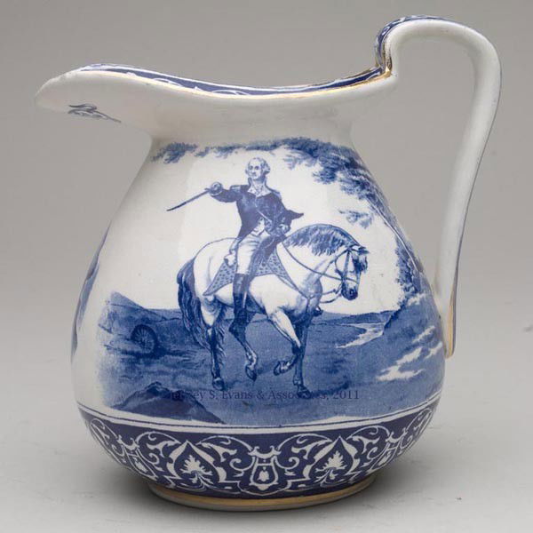 BUFFALO POTTERY GEORGE WASHINGTON JUG: BUFFALO POTTERY GEORGE WASHINGTON JUG, blue transfer decoration with gilt highlights, dated 1907. United States. 7 1/2" HOA. Provenance: Collection of Bertram (Bert) Cohen.