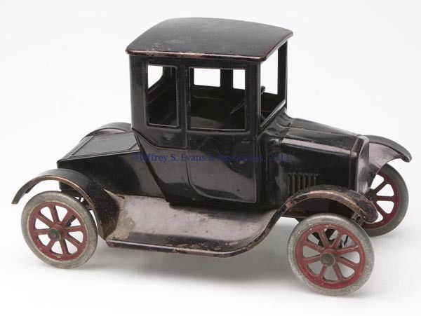 BUDDY "L" PRESSED STEEL MODEL T FLIVER TOY CAR: BUDDY "L" PRESSED STEEL MODEL T FLIVER TOY CAR metal wheels and tires with operable steering wheel, original black paint and underside label. Second quarter 20th century. 6 7/8" H, 5 3/4" x 11". Prove