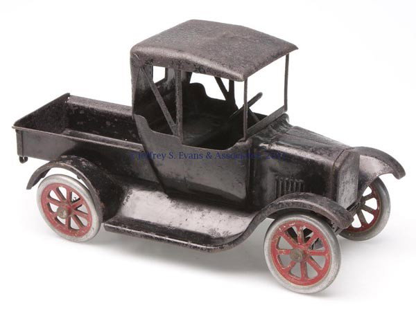 BUDDY "L" PRESSED STEEL TOY TRUCK: BUDDY "L" PRESSED STEEL TOY TRUCK metal wheels and tires with operable steering wheel, stationary bed with drop-down tailgate, original black paint and traces of underside label. Second quarter 20th c