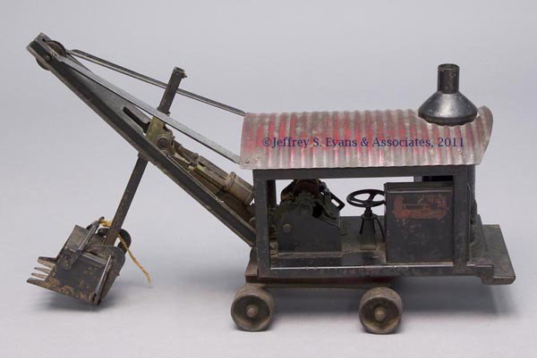 BUDDY "L" PRESSED STEEL IMPROVED TOY STEAM SHOVEL: BUDDY "L" PRESSED STEEL IMPROVED TOY STEAM SHOVEL body fitted on four cast wheels, bucket and geared hand wheel in working condition, boiler with hinged door, original dark red and old black re-paint,