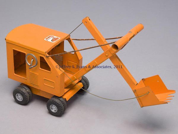 BUDDY "L" PRESSED STEEL TOY STEAM SHOVEL: BUDDY "L" PRESSED STEEL TOY STEAM SHOVEL body fitted on four composition tires, original orange paint, wheel rims repainted gray, "Buddy L Construction Company" maker's label to top of cab. Mid 20th c