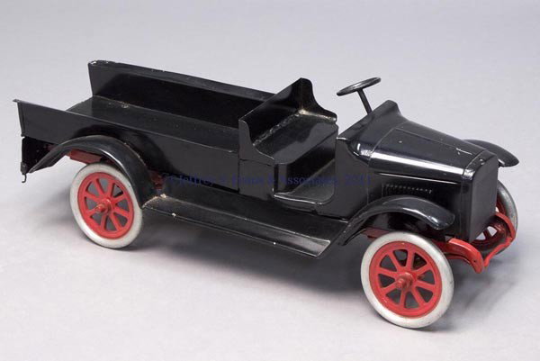 UNMARKED BUDDY "L" PRESSED STEEL TOY TRUCK: UNMARKED BUDDY "L" PRESSED STEEL TOY TRUCK metal wheels and tires with operable steering wheel, open cab and bed with lift-up tailgate, non-original black and red paint. Second quarter 20th century. 9