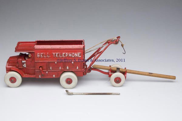 HUBLEY "BELL TELEPHONE" CAT-IRON TOY TRUCK: HUBLEY "BELL TELEPHONE" CAT-IRON TOY TRUCK red version with side-mount nickel water keg, winch and crank, trailer, pole and long-handle shovel, rubber tires probably replaced, original paint, marked "