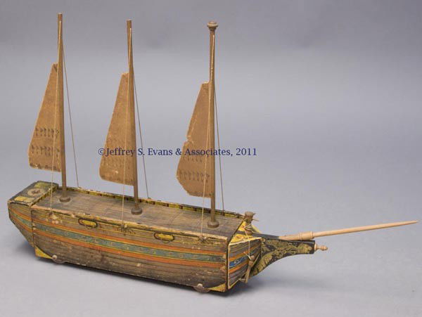 REED "OCEAN WAVE OF LEOMINSTER" SAILBOAT TOY: REED "OCEAN WAVE OF LEOMINSTER" SAILBOAT TOY lithographed paper on wood, lift-off top with original paperboard sails, patent dates stamped on top. Attributed to the W. S. Reed Toy Co., Leominster, MA.