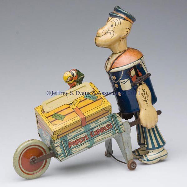 MARX "POPEYE EXPRESS" WIND-UP TIN TOY: MARX "POPEYE EXPRESS" WIND-UP TIN TOY walker figure pushing a wheelbarrow with pop-up parrot. First half 20th century. 8" H, 8 1/2" L. Provenance: Estate collection of Dorothy and Marshall Jenkins.