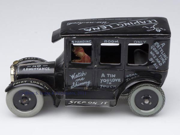 STRAUSS "LEAPING LENA" NOVELTY AUTO WIND-UP TIN TOY: STRAUSS "LEAPING LENA" NOVELTY AUTO WIND-UP TIN TOY complete with driver. First half 20th century. 4 1/4" H, 8 1/4" L. Provenance: Estate collection of Dorothy and Marshall Jenkins.