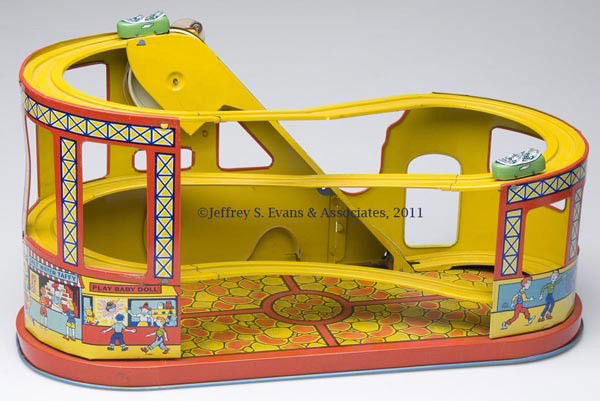 CHEIN "ROLLER COASTER" WIND-UP TIN TOY: CHEIN "ROLLER COASTER" WIND-UP TIN TOY variation with Side Show, two original cars and belt. Mid 20th century. 10" H, 8 1/4" x 19 1/2".