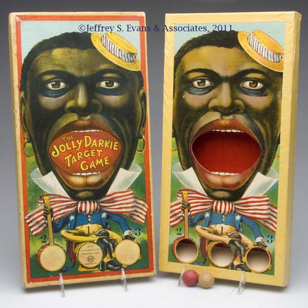 MILTON BRADLEY BLACK AMERICANA GAME: MILTON BRADLEY BLACK AMERICANA GAME "The Jolly Darkie Target Game", #4113, bold color lithography, with two wooden balls. First quarter 20th century. 16" x 8". Provenance: Collection of Bertram (Bert)