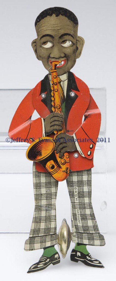 BLACK AMERICANA GERMAN SQUEEZE TOY: BLACK AMERICANA GERMAN SQUEEZE TOY depicting a saxophone player with moving eyes, arms and legs, marked "D. R. G. M" and "GERMANY". First half 20th century. 6 1/2" H. Provenance: Estate collection of 