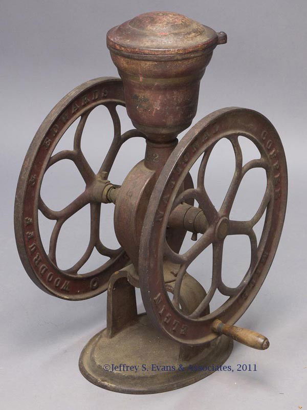 ELGIN NATIONAL CAST-IRON TWO-WHEEL COFFEE MILL: ELGIN NATIONAL CAST-IRON TWO-WHEEL COFFEE MILL swivel lid lacking finial, "42" stenciled below hopper, oval base, worn original paint. Late 19th/early 20th century. 26" HOA, 17" D wheels.