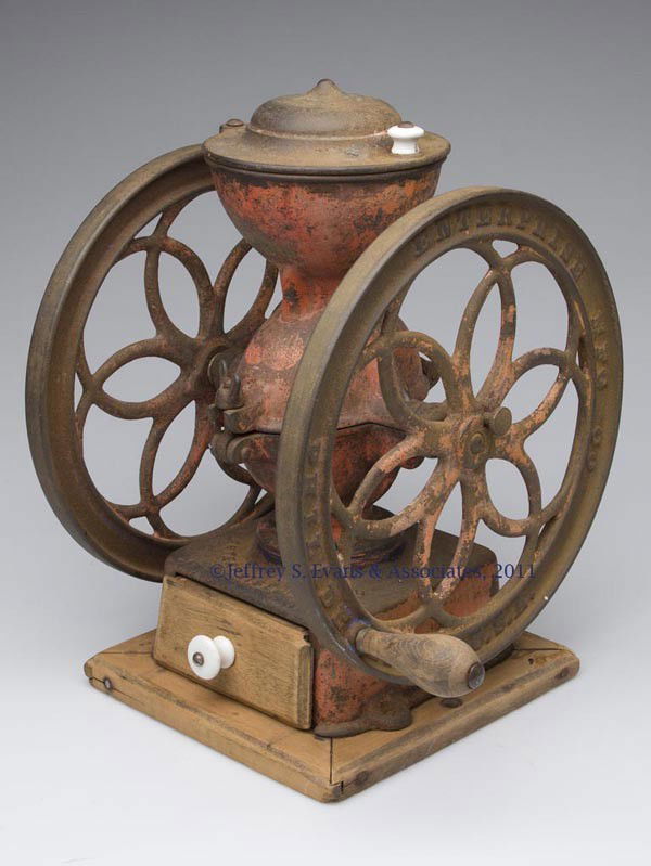 ENTERPRISE CAST-IRON TWO-WHEEL COFFEE MILL: ENTERPRISE CAST-IRON TWO-WHEEL COFFEE MILL swivel lid, original wooden and base, worn original paint. Late 19th/early 20th century. 14 1/2" HOA, 10 3/4" D wheels.
