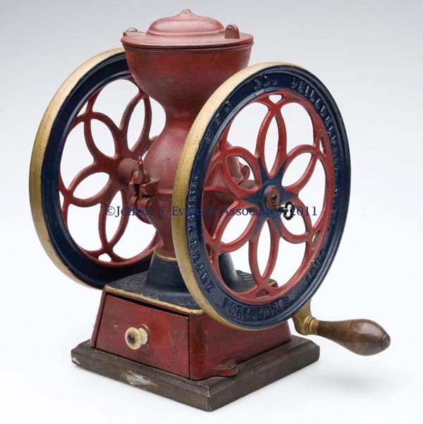 ENTERPRISE CAST-IRON TWO-WHEEL COFFEE MILL: ENTERPRISE CAST-IRON TWO-WHEEL COFFEE MILL swivel lid and original drawer, mounted on a wooden base, repainted. Late 19th/early 20th century. 12 3/4" HOA, 8 3/4" D wheels.