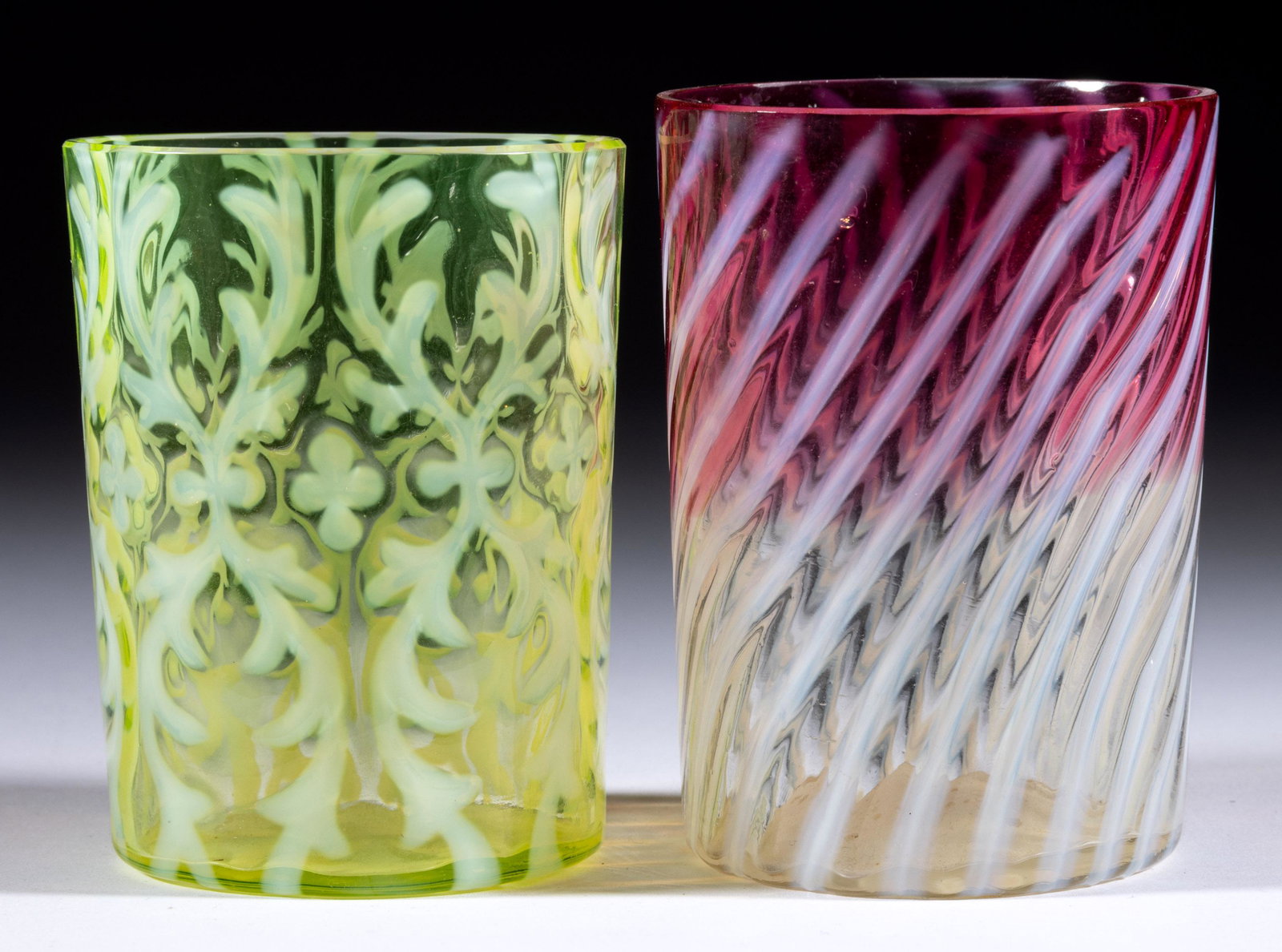 ASSORTED OPALESCENT GLASS TUMBLERS, LOT OF TWO,: ASSORTED OPALESCENT GLASS TUMBLERS, LOT OF TWO,comprising a Vaseline opalescent (reacts under black light) Spanish Lace, and a rubina opalescent Swirl.Northwood Glass Co. and others.Late 19th/early 20