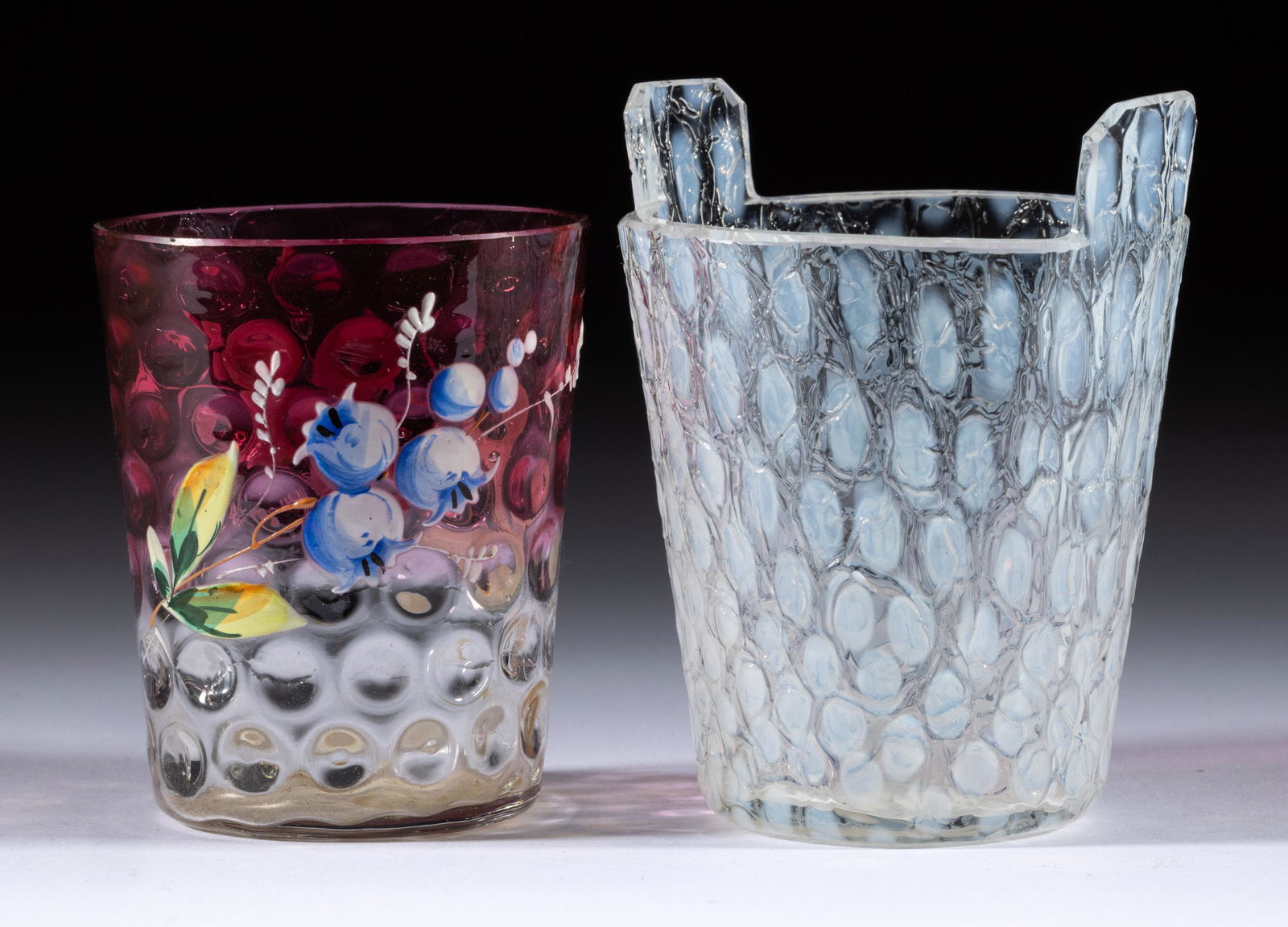 ASSORTED PHOENIX GLASS TOOTHPICK HOLDERS, LOT OF TWO,: ASSORTED PHOENIX GLASS TOOTHPICK HOLDERS, LOT OF TWO,comprising a colorless opalescent Spot-Optic with a craquelled surface and tab handles, and a rubina tumbler form with polychrome-enamel decoration