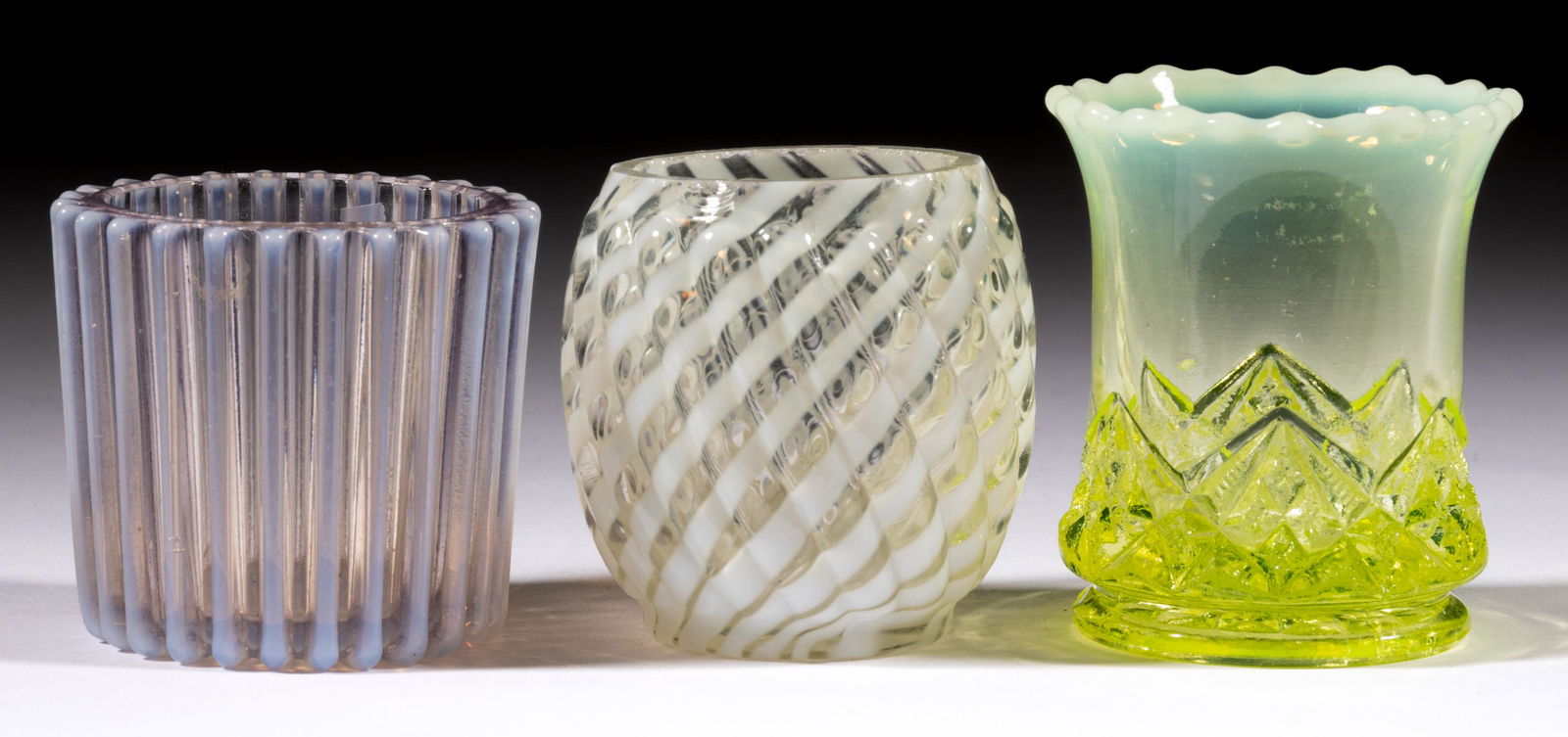 ASSORTED OPALESCENT TOOTHPICK HOLDERS, LOT OF THREE: ASSORTED OPALESCENT TOOTHPICK HOLDERS, LOT OF THREE, comprising a vaseline opalescent (reacts under blacklight) Diamond Spearhead, and colorless opalescent Beatty Rib and Reverse Swirl. Late 19th/firs