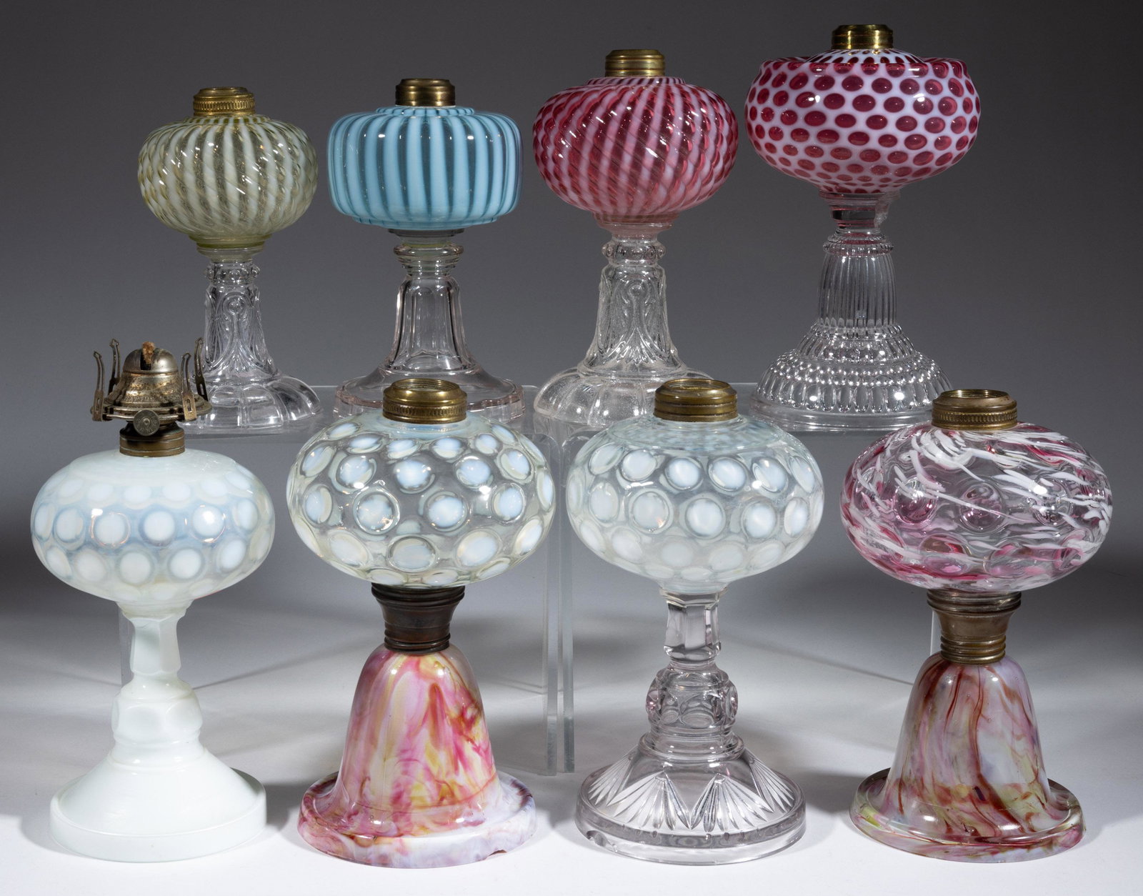 ASSORTED VICTORIAN AND OPALESCENT GLASS KEROSENE STAND LAMPS, LOT OF EIGHT,: ASSORTED VICTORIAN AND OPALESCENT GLASS KEROSENE STAND LAMPS, LOT OF EIGHT,various colors,including a Hobbs Windows, Sheldon Swirl, a Coinspot with a spatter base, and an Spot-Optic with cranberry and