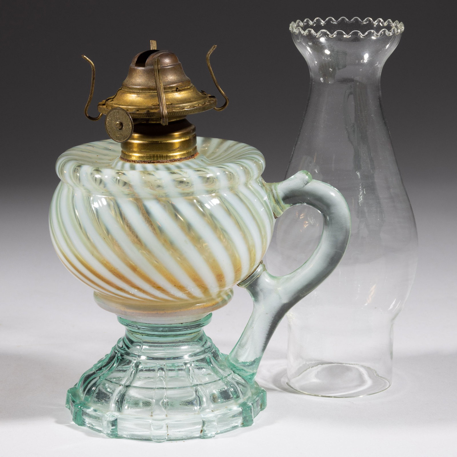 MIX AND MATCH KEROSENE FOOTED FINGER LAMP,: MIX AND MATCH KEROSENE FOOTED FINGER LAMP,teal opalescent,molded handle, No. 1 Taplin-Brown collar. Fitted with a period slip burner and chimney.Fourth quarter 19th century.5 1/2" H to top of collar. 