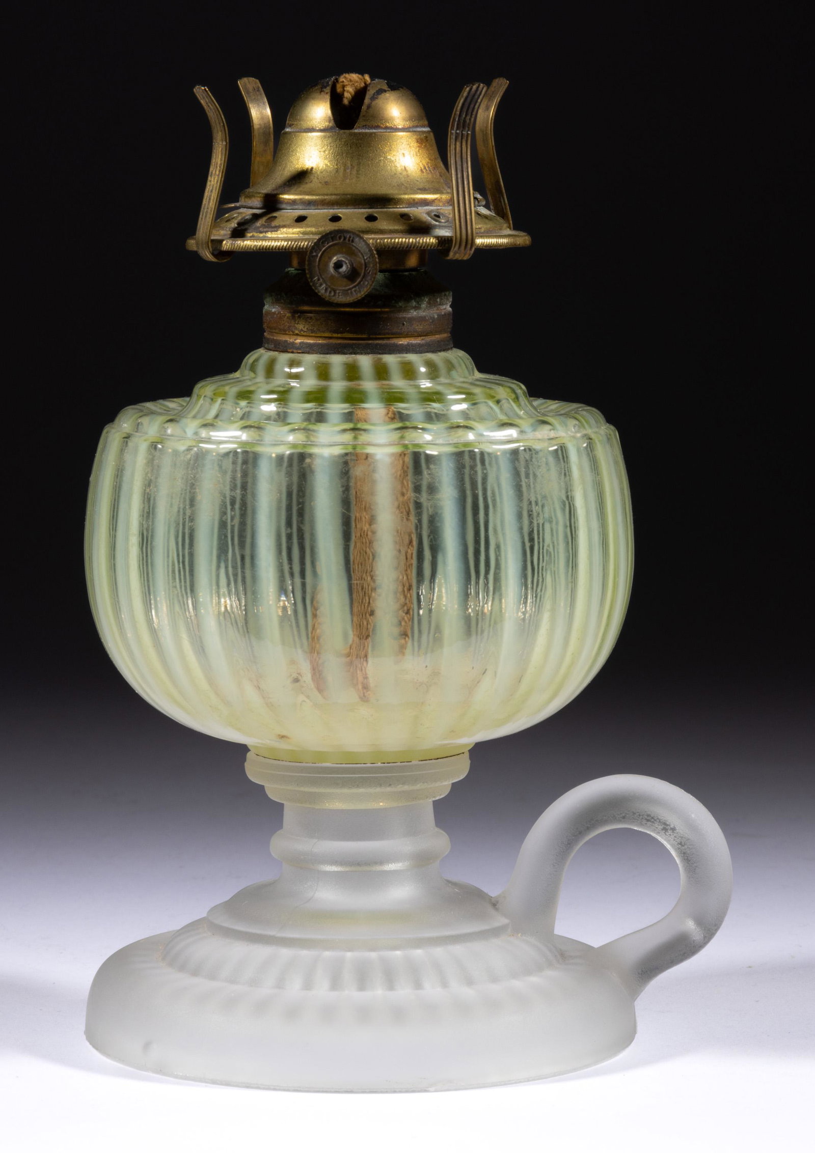 VENETIAN / VENICE KEROSENE FOOTED FINGER LAMP,: VENETIAN / VENICE KEROSENE FOOTED FINGER LAMP,Vaseline (reacts under black light) opalescent stripe font,drip-guard shoulder, frosted colorless base with molded handle, period No. 1 collar. Fitted wit