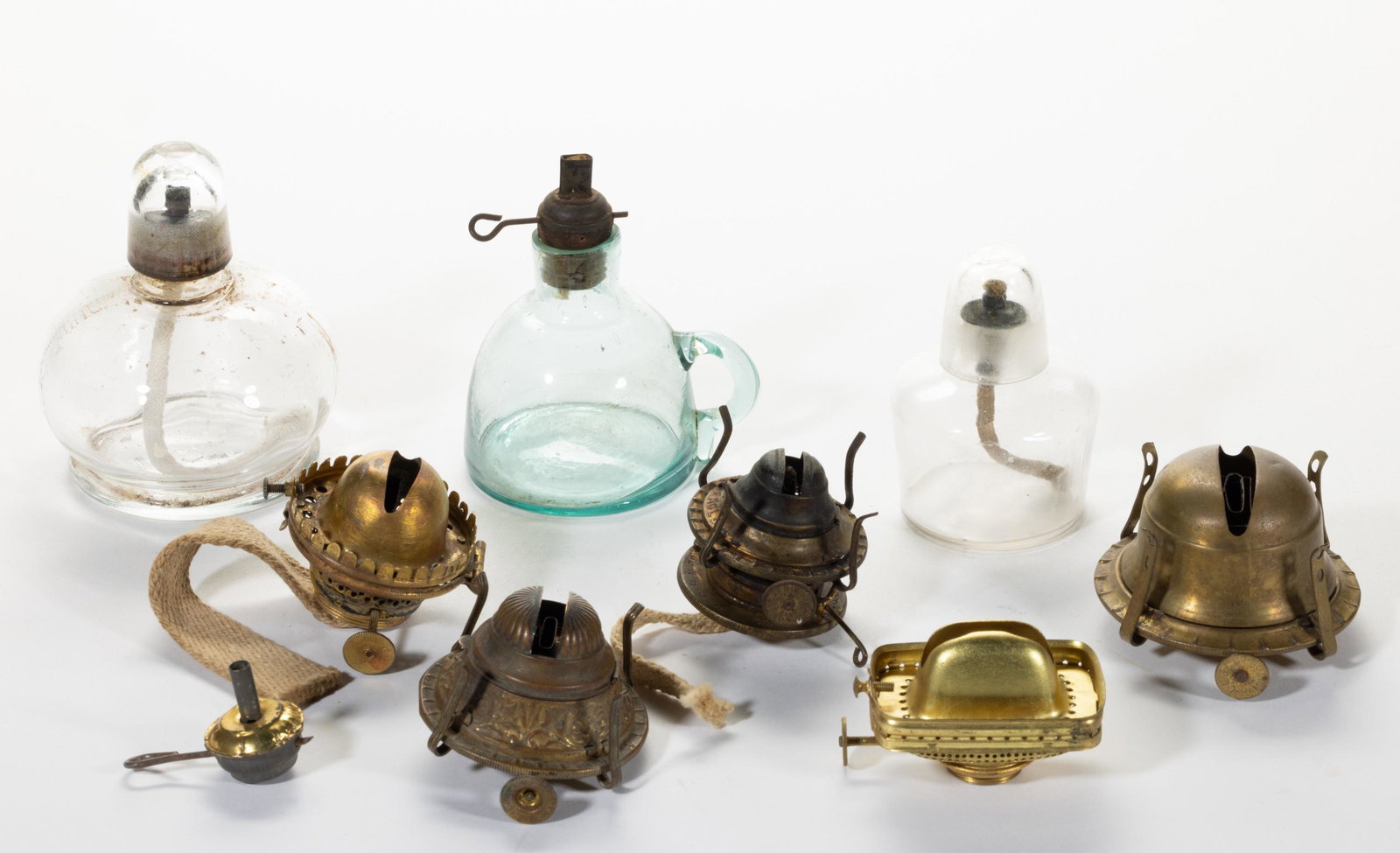 ASSORTED LIGHTING ARTICLES, LOT OF NINE,: ASSORTED LIGHTING ARTICLES, LOT OF NINE,comprising three domed glass lamps with two having glass caps, and six loose burners.Various makers.19th and 20th century.1 1/4" to 4 1/4" H.. Provenance:Michae