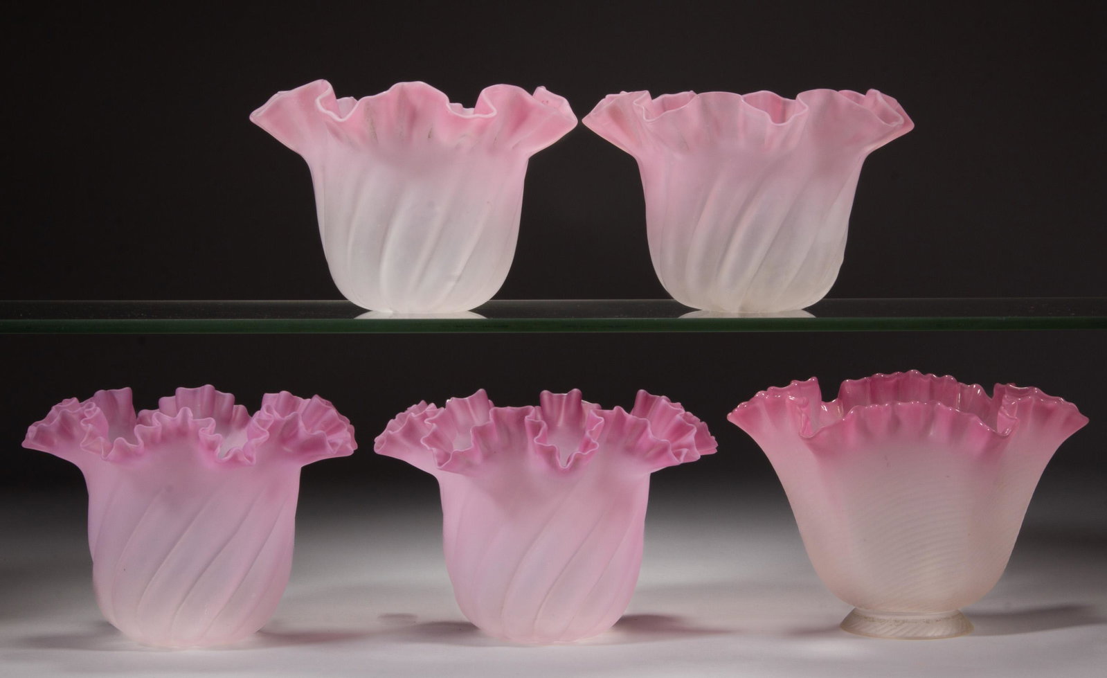 ASSORTED RIBBED AND SATIN GLASS MINIATURE LAMP SHADES, LOT OF FIVE: ASSORTED RIBBED AND SATIN GLASS MINIATURE LAMP SHADES, LOT OF FIVE, dark to light pink/rose with satin finish, comprising four matching patterned swirled panel rib examples, one pair with slightly mor