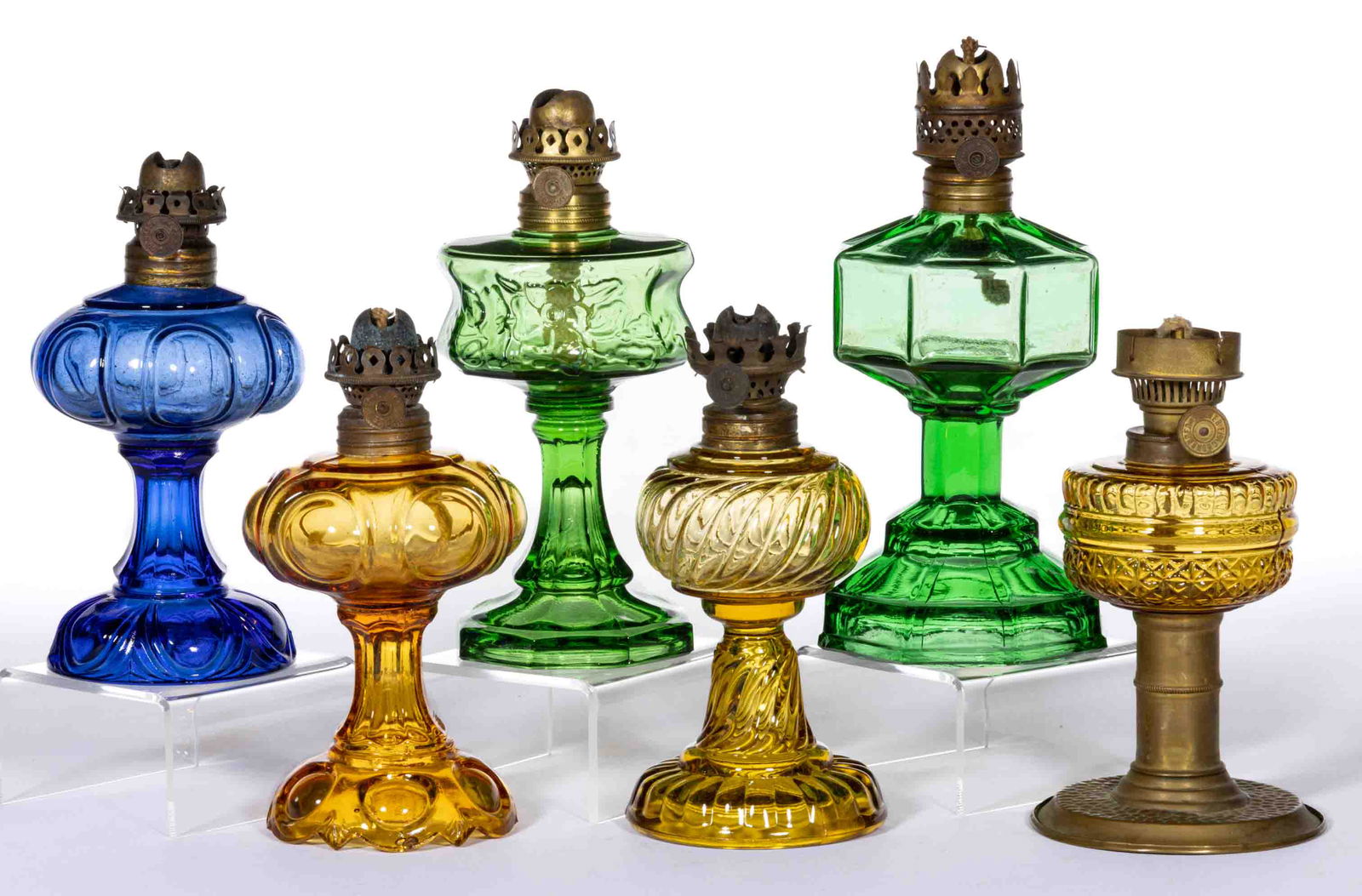 ASSORTED PATTERN COLORED GLASS MINIATURE STAND LAMPS, LOT OF SIX: ASSORTED PATTERN COLORED GLASS MINIATURE STAND LAMPS, LOT OF SIX,amber, blue and green,including an Octavia/Smith I, fig. 106; a Bullseye/Smith I, fig. 111; a Daisy/Smith I, fig. 112; a Riverside Rose