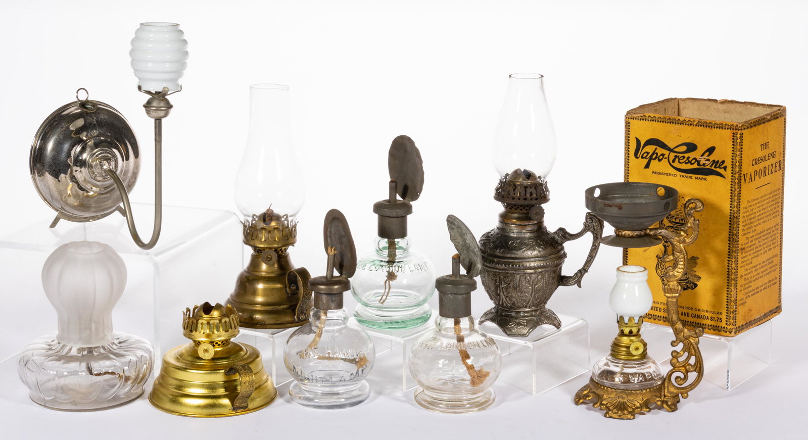 ASSORTED GLASS AND METAL MINIATURE LAMPS, LOT OF NINE: ASSORTED GLASS AND METAL MINIATURE LAMPS, LOT OF NINE,colorless glass, including two The London Lamp/Smith I, fig. 4 examples; a Handy/Smith I, fig. 5 right; a glow lamp/Smith I, fig. 624; a Vapo-Cres