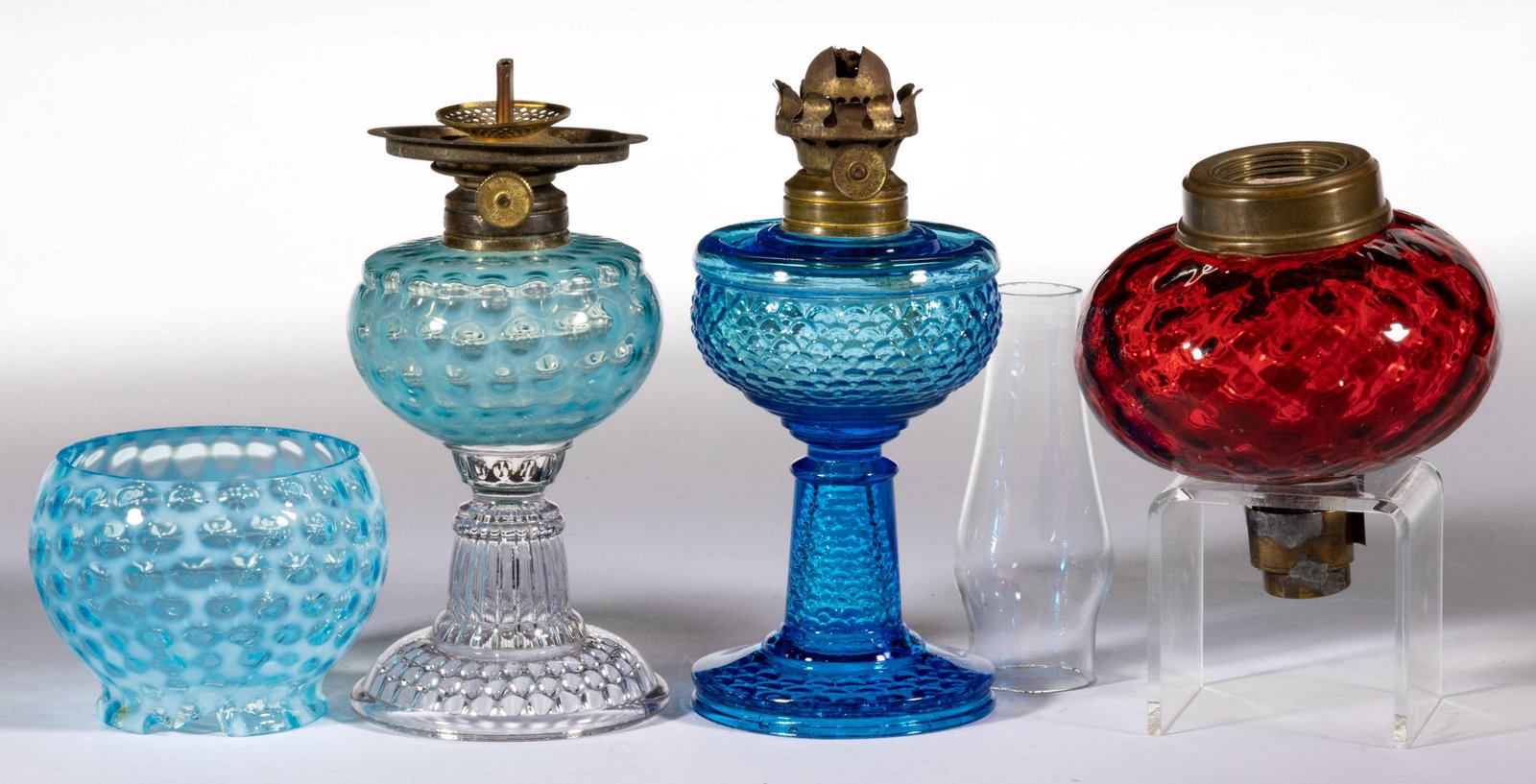 ASSORTED GLASS KEROSENE LIGHTING ARTICLES, LOT OF THREE,: ASSORTED GLASS KEROSENE LIGHTING ARTICLES, LOT OF THREE,comprising a blue opalescent Hobbs Windows miniature lamp with matching shade, a deep ruby Diamond-Quilt peg lamp, and a blue Fishscale miniatur