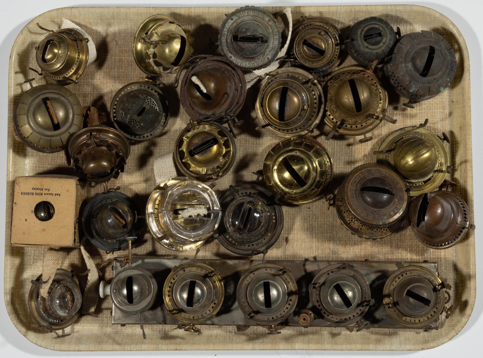 ASSORTED KEROSENE LAMP BURNERS, LOT OF 27: ASSORTED KEROSENE LAMP BURNERS, LOT OF 27,various manufacturers including four examples with glass deflectors, including two Bing examples with one in originial box and unused, two Radiants and a Gett
