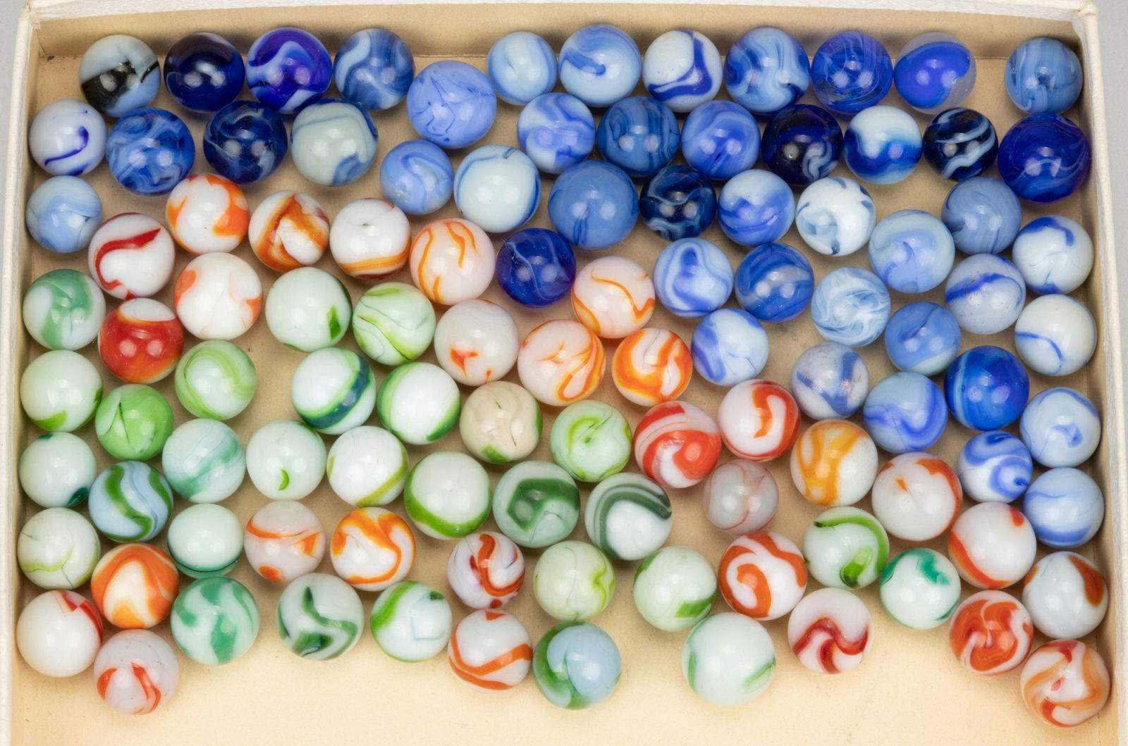 ALLEY AGATE MACHINE-MADE GLASS MARBLES, LOT OF 105: ALLEY AGATE MACHINE-MADE GLASS MARBLES, LOT OF 105,colors featuring blue and white, opaque white base color with swirls of blue, opaque white/clambroth with orange or red swirling, and opaque white or