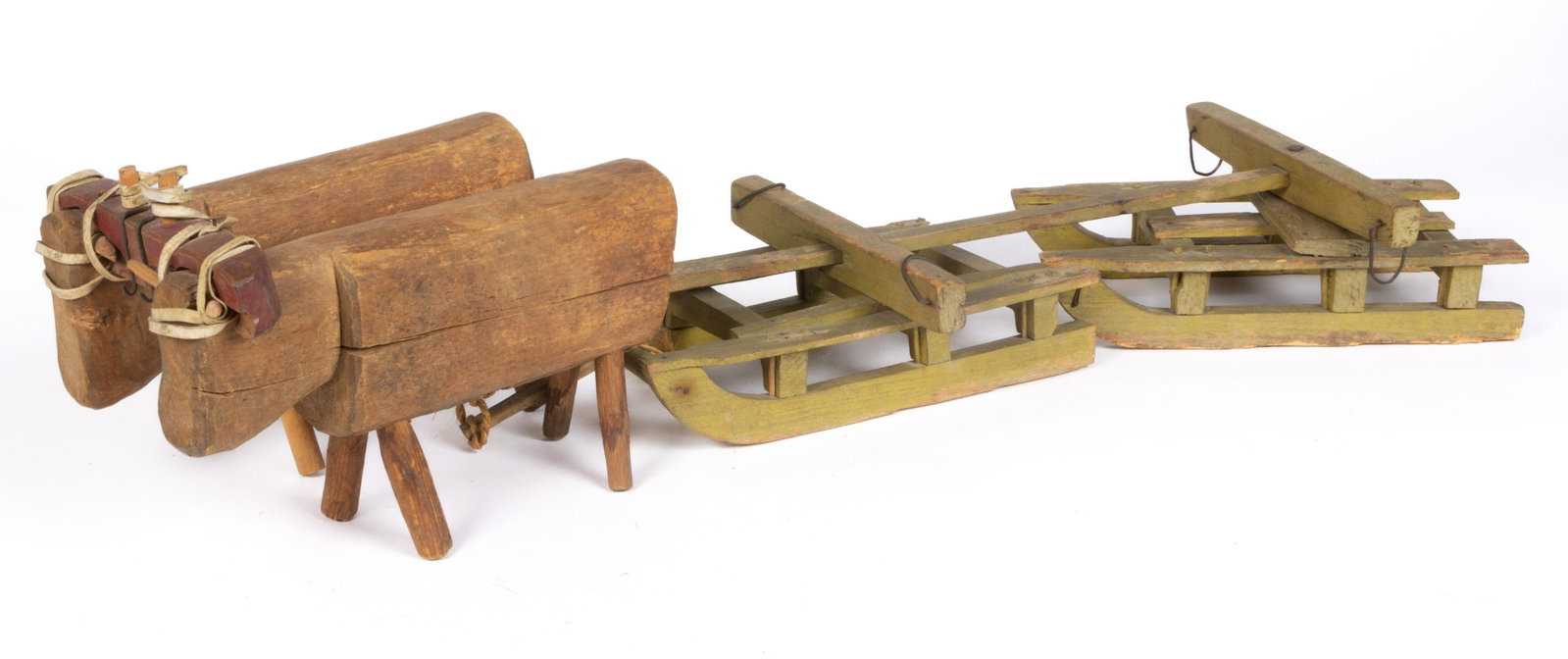 NEW ENGLAND FOLK ART CARVED AND PAINTED WOODEN OXEN AND SLEDGE TOY: NEW ENGLAND FOLK ART CARVED AND PAINTED WOODEN OXEN AND SLEDGE TOY, oxen with dry natural surface, head yoke with original red-painted surface, and sledge with original green-painted surface. Fourth q