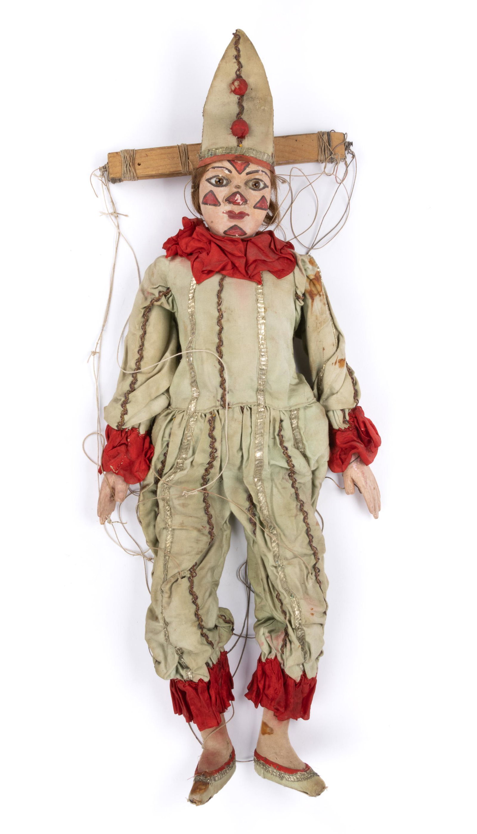GERMAN CARVED AND PAINTED CLOWN MARIONETTE: GERMAN CARVED AND PAINTED CLOWN MARIONETTE,featuring wooden head with applied glass eyes, carved nose and ears, jointed legs, and wearing period attire.Circa 1900.30" H. Provenance: From a Virginia pr